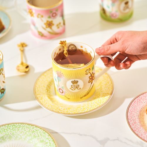 Yellow Queen Elizabeth II Centenary mug with floral details and central yellow cypher. 