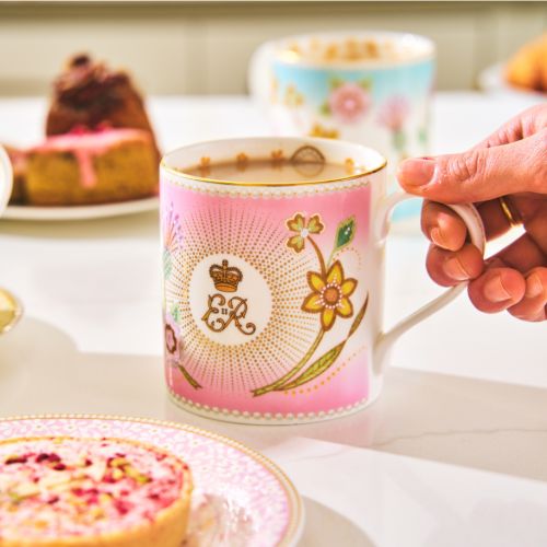 Queen Elizabeth II pink commemorative mug with floral details and central ER Cypher. 