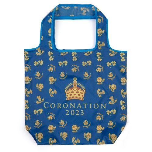 Blue bag with gold floral illustrations, a crown and 'Coronation 2023'
