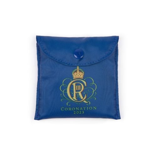 Blue bag with gold floral illustrations, a crown and 'Coronation 2023'