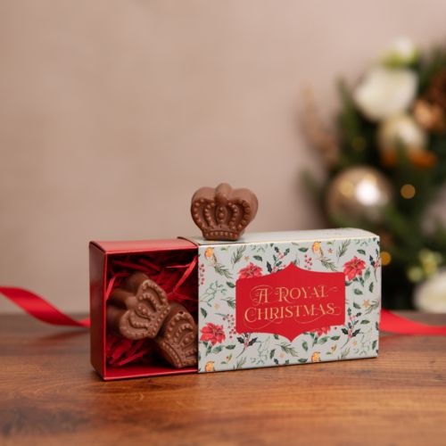 small box of three chocolate coins inside with a royal christmas written on the packaging and gold foil stars to decorate 