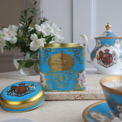 Shot of a blue and gold cube tea caddy featuring the Royal Coat of Arms including a lion and unicorn. 