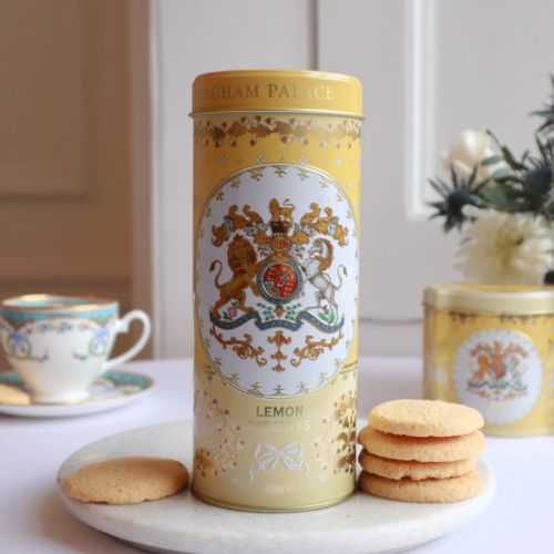 yellow tin with floral decoration and the crest and the centre of the tin. Stood next to a few biscuits