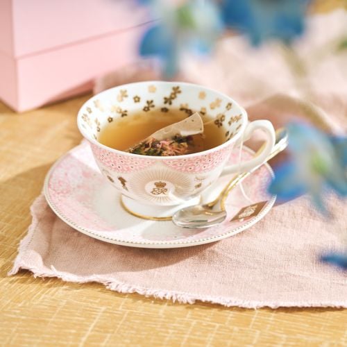 Pink foral Queen Elizabeth II teacup and saucer with central ER cypher and gold details. 