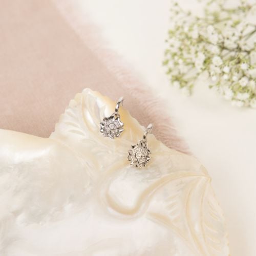 two silver drop earrings in a rose shape 