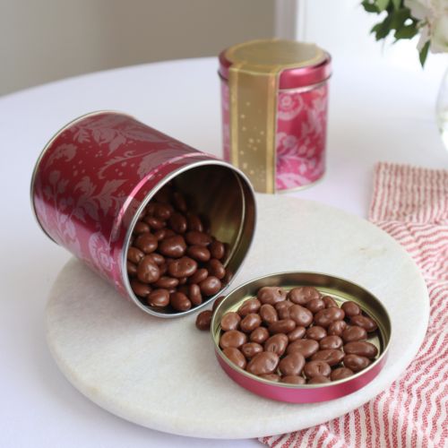 Pink tin with acanthus print pattern. Wrapped in gold cardboard. 