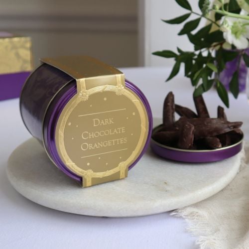 Purple tin with acanthus print and gold cardboard wrap. 