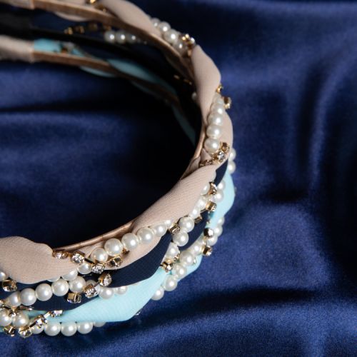 Light blue fabric wrapped with costume pearls and crystals. 