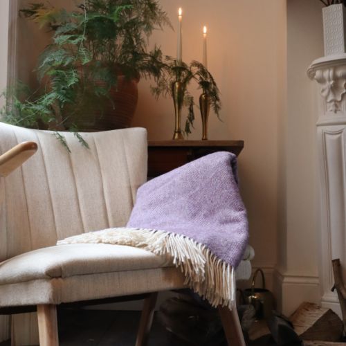 Purple herringbone blanket with white tassels and Palace of Holyroodhouse label sewn in bottom right corner.