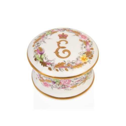Fine bone china pillbox decorated with Princess Elizabeth's cypher as the central motif. Surrounding the cypher is floral arrangements, cherubs and feathers. Finished with gold leaf. 