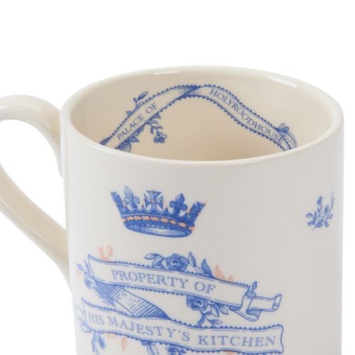 Cream earthenware mug with blue typeface and copper detailing stating property of His Majesty's kitchen.