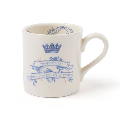 Cream earthenware mug with blue typeface and copper detailing that states property of Her Majesty's kitchen.