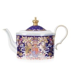 Purple teapot with the Longest Reining Monarch design. With the lion and unicorn crest, gold crown lid and white handle and spout