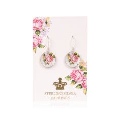 Round drop earrings decorated with a pink rose design. It is on a pale pink backing card decorated with pink roses and a gold crown