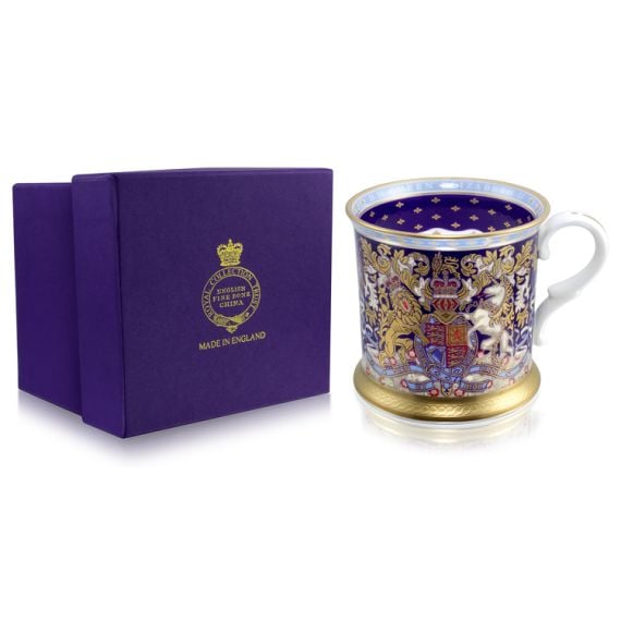 Gold, purple and light blue tankard with the lion and unicorn crest at the centre of the tankard. Next to the tankard is the purple presentation box.
