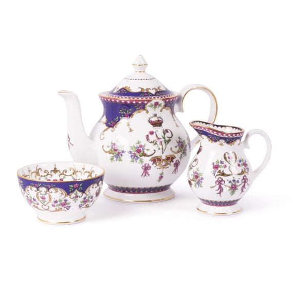 The full Queen Victoria fine porcelain tea set with a design featuring Queen Victoria's name cipher, gold plated rims and floral patterns. The range includes teapot,  cream jug and sugar bowl. 