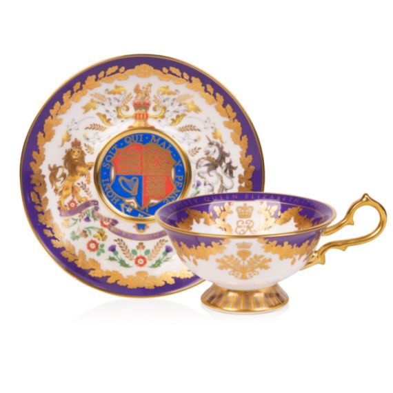 Platinum Jubilee Limited Edition Teacup and Saucer. The saucer displays the coat of arms and is surrounded by a purple and gold leaf design. The teacup has a gold handle and gold base and EIIR on the inside of the cup.