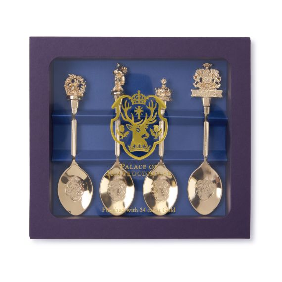 Purple outer box containing four gold plated Palace of Holyrood house decorative spoons. Purple outer box containing four gold plated Palace of Holyrood house decorative spoons.