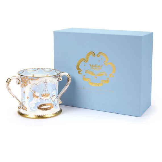 2013 limted edition number one Loving Cup featuring a lion and unicorn with gold detailing adjacent to a blue box with "Welcome to our Royal Baby" embossed in gold. 2013 limted edition number one Loving Cup featuring a lion and unicorn with gold detailing adjacent to a blue box with "Welcome to our Royal Baby" embossed in gold.