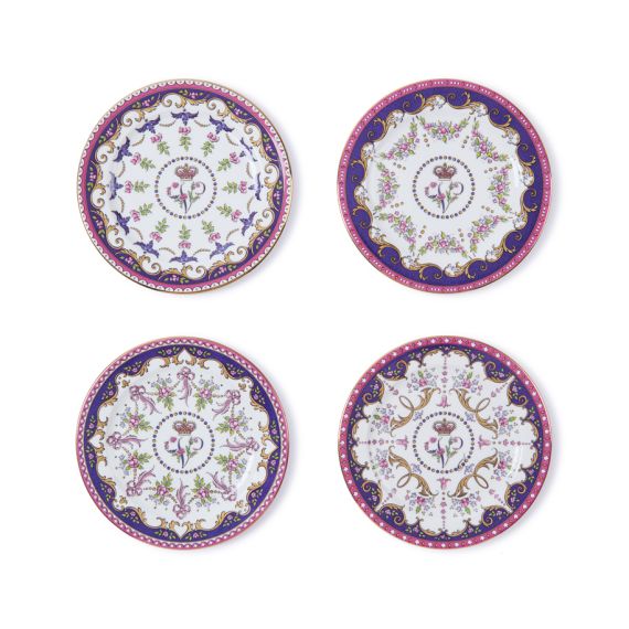 Four individual miniature Queen Victoria Plates, each featuring unique designs with purple and pink pink detailing as well as a central V cypher. 