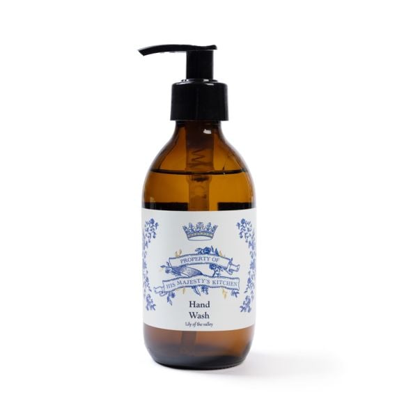 Brown hand pump bottle of His Majesty’s Kitchen hand wash with a cream label and blue text.