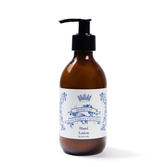 Brown hand pump bottle of His Majesty’s Kitchen hand lotion with a cream label and blue text.