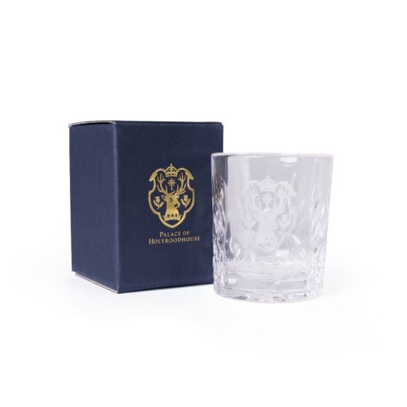 Clear cut-glass tot glass engraved with the Palace of Holyroodhouse emblem, shown beside a navy box with gold crest and text.