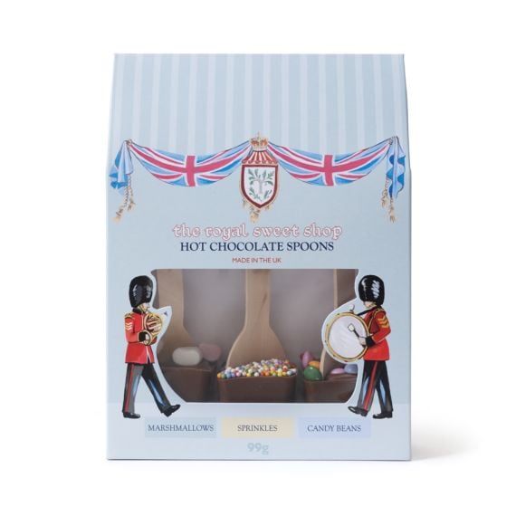 Gift box of hot chocolate spoons with Union Jack bunting and Guards illustrations, showing three milk chocolate cups with wooden spoons and toppings including marshmallows, sprinkles and candy beans.
