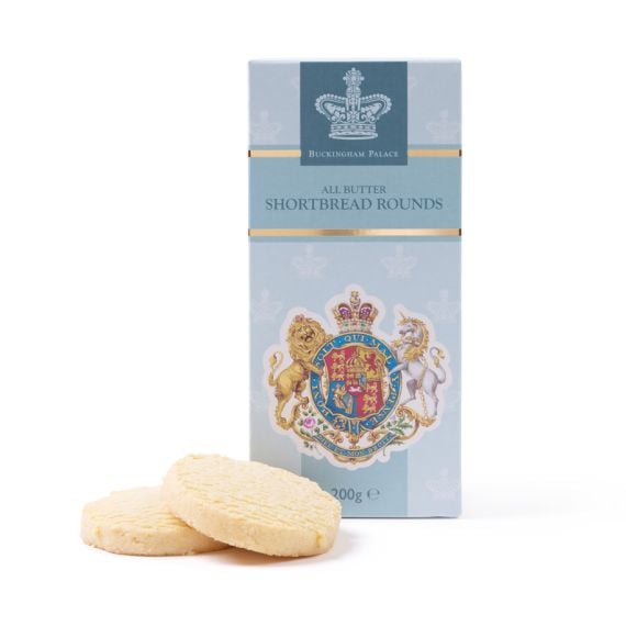 Buckingham Palace All Butter Shortbread Rounds in a light blue presentation box featuring the Royal Coat of Arms, with two round shortbread biscuits placed in front of the packaging.