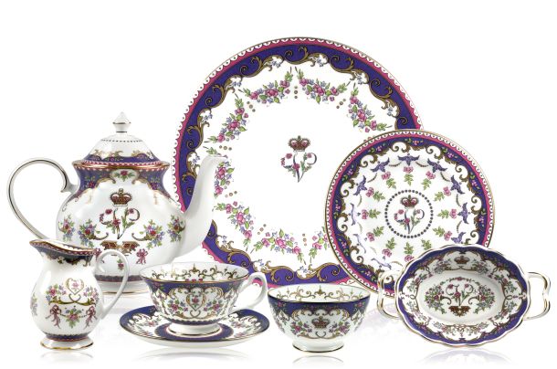 The full Queen Victoria fine bone china tea set with a design featuring Queen Victoria's name cipher, gold plated rims and floral patterns. The range includes teapot, teacup and saucer, cream jug, sugar bowl, side plate, candy basket and dinner plate.