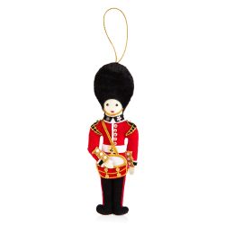 Guardsman decoration beating a drum. Wearing a red uniform and black busby, the decoration is embroidered with gold thread and bead detail