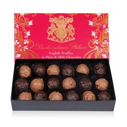 pink box of chocolate truffles with a gold swirl design and the crest at the centre of the design
