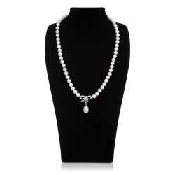 Pearl necklace with a magnetic clasp. There is a crystal bow detail with a pearl drop