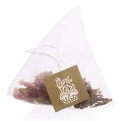 open shot of the cardboard box of White Tea, Rose and Pomegranate Tea Bags with a pink and white design and the lion and unicorn crest at the front of the box. Inside are teabags in individual pink packets