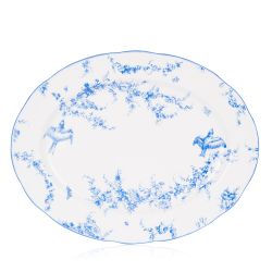 A white oval platter with blue floral garland and bird design.