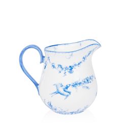 A white cream jug with blue floral garland and bird design.