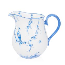 A white milk jug with blue floral garland and bird design.