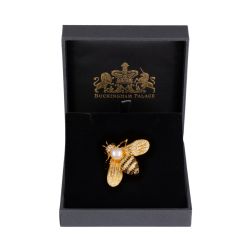 gold bee brooch with a pearl centre and black and gold coloured jewels