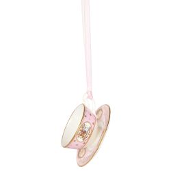 Miniature pink teacup and saucer with gold crown detail. It is  hanging from a pink ribbon