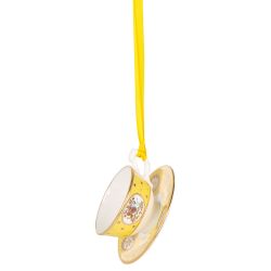 Miniature yellow teacup and saucer with gold crown detail. It is  hanging from a yellow ribbon