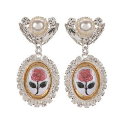 A pair of drop stud earrings with a pink rose print at the centre. Surrounded by crystals and topped with crystals and a pearl.