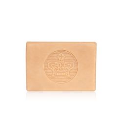bar of soap wrapped in blue paper printed with tuberose and tonka beans. There is also a gold seal with a crown and a white box saying 'Buckingham Palace Tuberose and Tonka Premium English Soap Handmade in London'