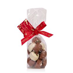 Clear bag of white and milk chocolates with holly and berries on top. Wrapped with a red Buckingham Palace ribbon