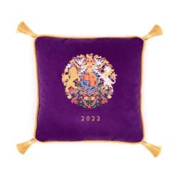 Purple velvet cushion with gold tassels. At the centre of the cushion is the coat of arms and the year 2022 embroidered