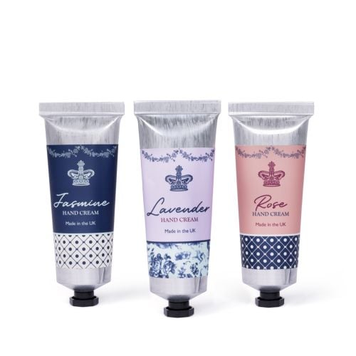 Three aluminium hand cream tubes in Jasmine (navy), Lavender (lilac) and Rose (pink) designs with crown motifs and “Made in the UK” branding.