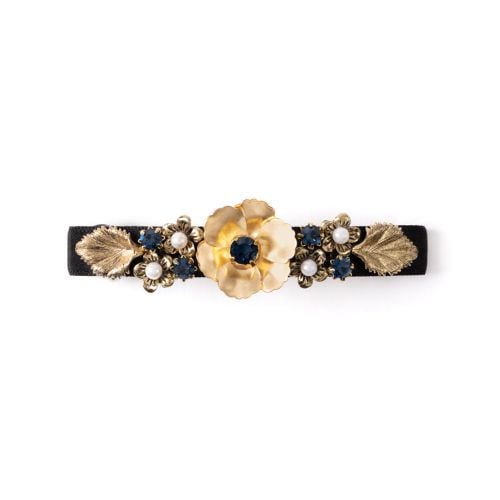 Hair clip with gold flower details and pearl and gem studs. 
