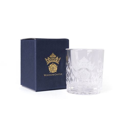 Clear cut-glass tumbler engraved with the Windsor Castle crest, shown beside a navy box with gold crest and text.